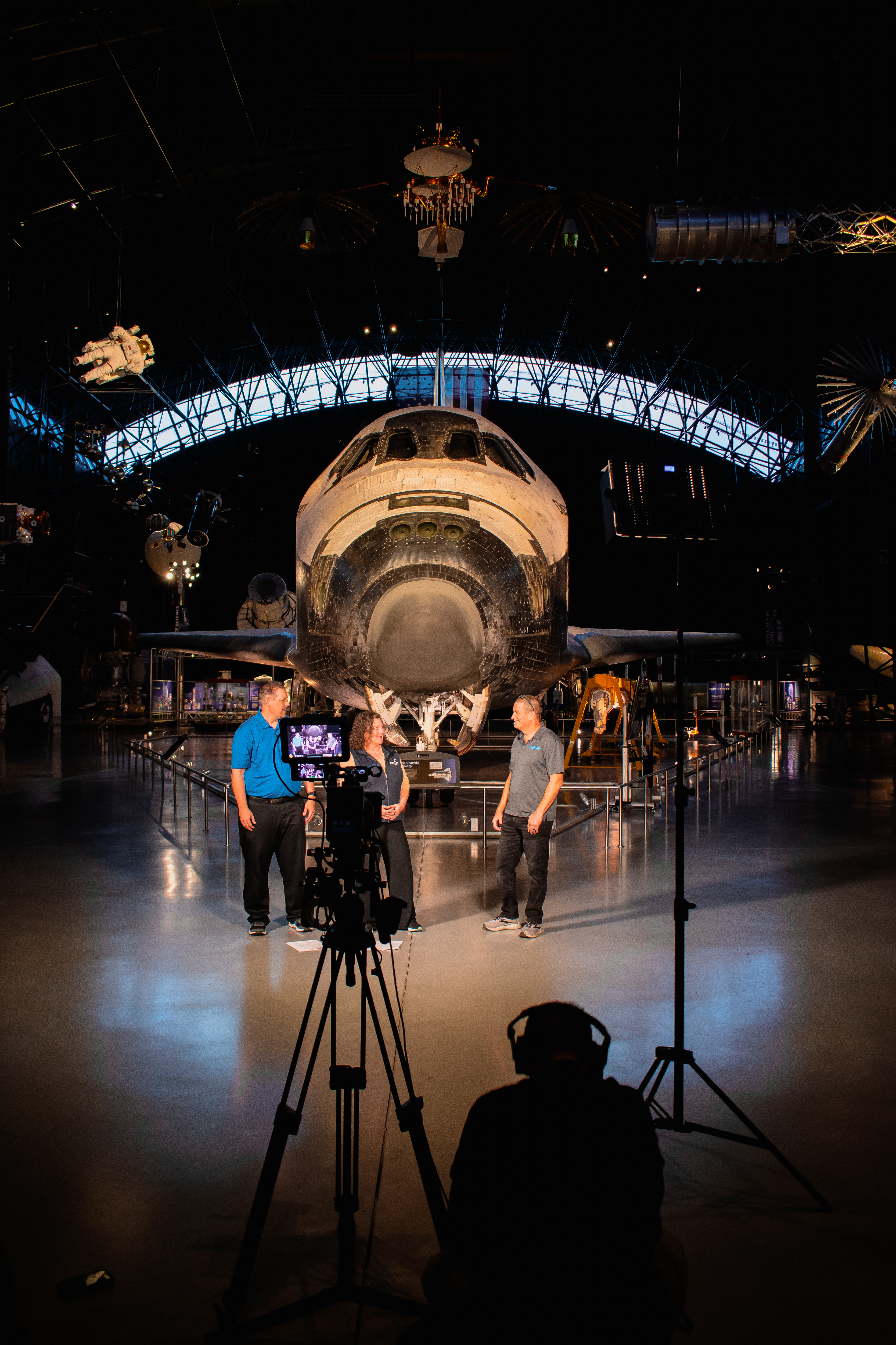 Taping in front of Space Shuttle.